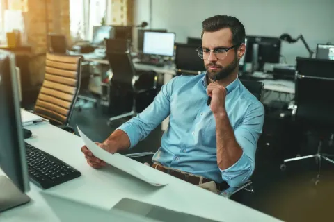 Professional reviewing documents in a modern office